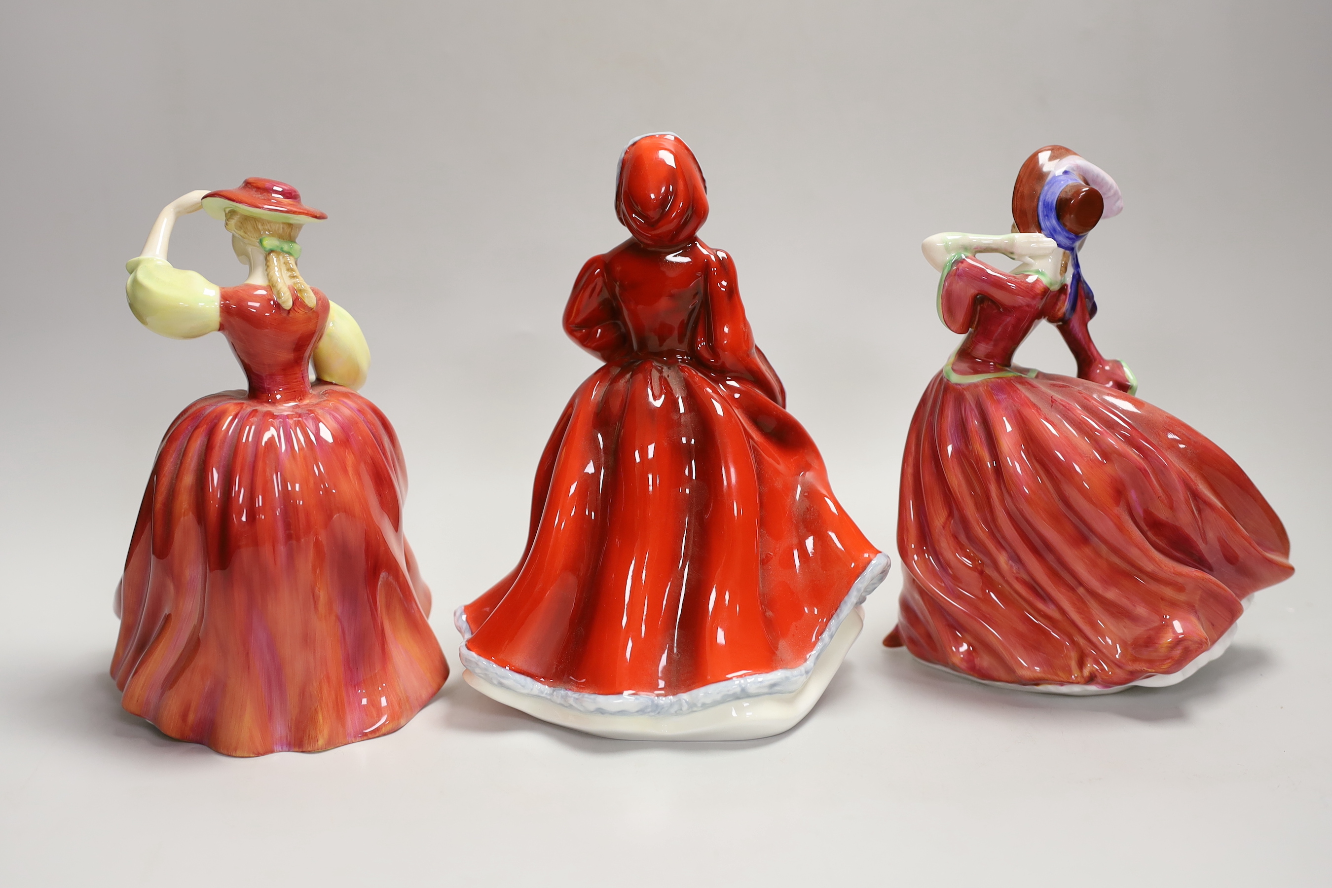 Three Royal Doulton figures: Rachel HN2936, Buttercup HN2399, Autumn Breezes HN1934, tallest 20cm